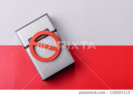 A metal cigarette box with a no smoking sign depicts a harmful habit. A cigarette box A metal cigarette box with a no smoking sign depicts a harmful habit. A cigarette box 138093113