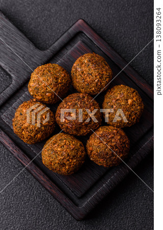 Falafel, a hearty Arabic dish made from boiled chickpeas for vegetarians. Chickpea falafel Falafel, a hearty Arabic dish made from boiled chickpeas for vegetarians. Chickpea falafel 138093264