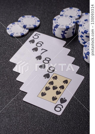 Playing cards and chips on a table, a gambling game of poker. Cards and chips Playing cards and chips on a table, a gambling game of poker. Cards and chips 138093314