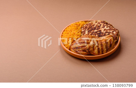 Dajaj Mashwi, an Arabic dish with rice and chicken, salt, and spices. Dajaj Mashwi as a background Dajaj Mashwi, an Arabic dish with rice and chicken, salt, and spices. Dajaj Mashwi as a background 138093799