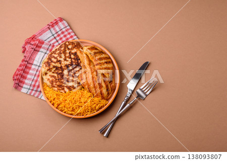 Dajaj Mashwi, an Arabic dish with rice and chicken, salt, and spices. Dajaj Mashwi as a background Dajaj Mashwi, an Arabic dish with rice and chicken, salt, and spices. Dajaj Mashwi as a background 138093807