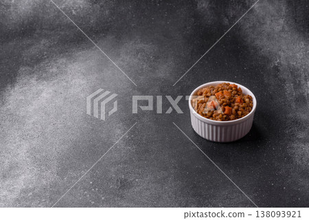 Lentil, carrot, and tomato stew with sausages, a European dish. Lentils with sausages 138093921