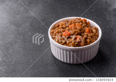 Lentil, carrot, and tomato stew with sausages, a European dish. Lentils with sausages Lentil, carrot, and tomato stew with sausages, a European dish. Lentils with sausages 138093924