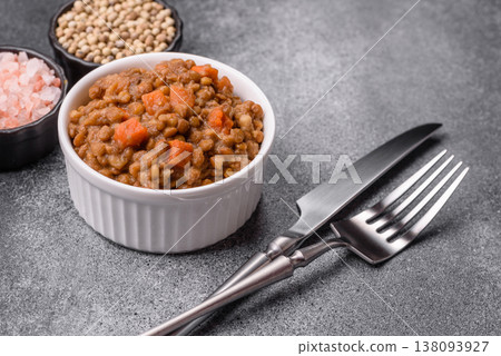 Lentil, carrot, and tomato stew with sausages, a European dish. Lentils with sausages 138093927