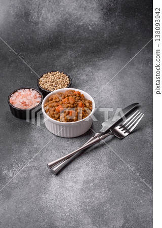 Lentil, carrot, and tomato stew with sausages, a European dish. Lentils with sausages 138093942