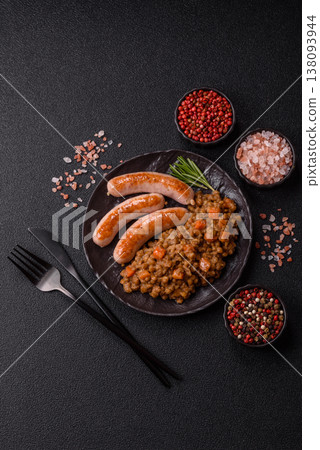 Lentil, carrot, and tomato stew with sausages, a European dish. Lentils with sausages Lentil, carrot, and tomato stew with sausages, a European dish. Lentils with sausages 138093944