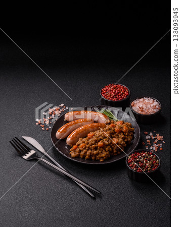 Lentil, carrot, and tomato stew with sausages, a European dish. Lentils with sausages Lentil, carrot, and tomato stew with sausages, a European dish. Lentils with sausages 138093945