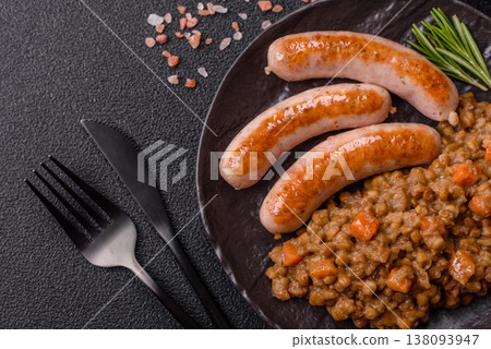Lentil, carrot, and tomato stew with sausages, a European dish. Lentils with sausages 138093947