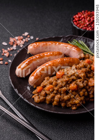 Lentil, carrot, and tomato stew with sausages, a European dish. Lentils with sausages 138093948