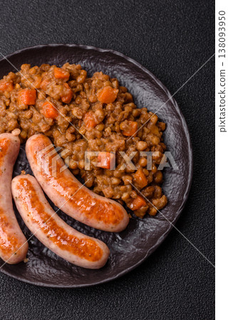 Lentil, carrot, and tomato stew with sausages, a European dish. Lentils with sausages 138093950