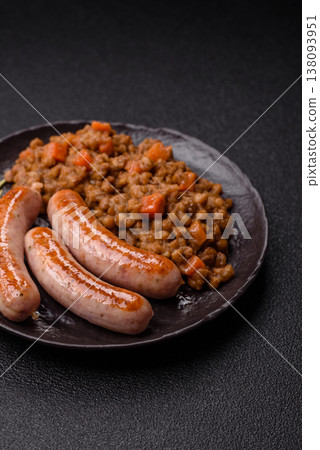 Lentil, carrot, and tomato stew with sausages, a European dish. Lentils with sausages 138093951