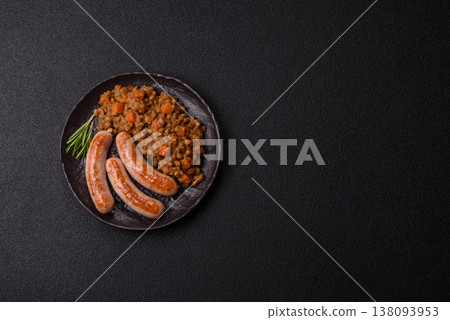 Lentil, carrot, and tomato stew with sausages, a European dish. Lentils with sausages 138093953