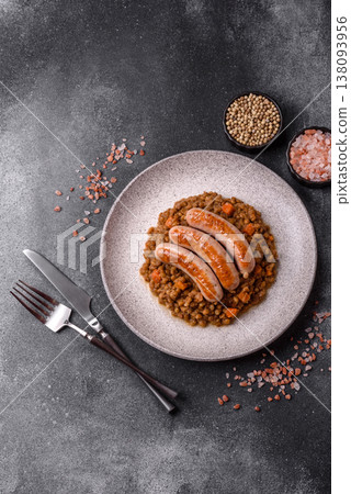 Lentil, carrot, and tomato stew with sausages, a European dish. Lentils with sausages Lentil, carrot, and tomato stew with sausages, a European dish. Lentils with sausages 138093956