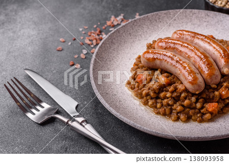 Lentil, carrot, and tomato stew with sausages, a European dish. Lentils with sausages 138093958