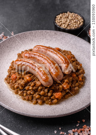 Lentil, carrot, and tomato stew with sausages, a European dish. Lentils with sausages Lentil, carrot, and tomato stew with sausages, a European dish. Lentils with sausages 138093960