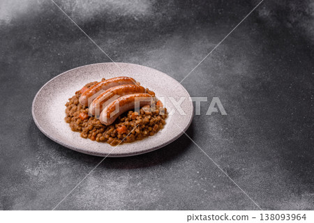 Lentil, carrot, and tomato stew with sausages, a European dish. Lentils with sausages 138093964