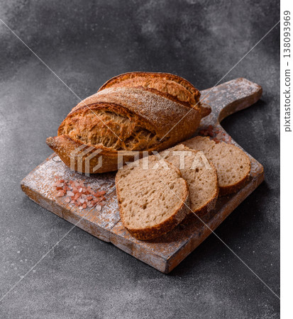 A loaf of homemade whole grain rye bread for the dinner table. A loaf of rye bread A loaf of homemade whole grain rye bread for the dinner table. A loaf of rye bread 138093969