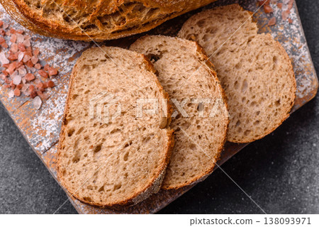 A loaf of homemade whole grain rye bread for the dinner table. A loaf of rye bread A loaf of homemade whole grain rye bread for the dinner table. A loaf of rye bread 138093971