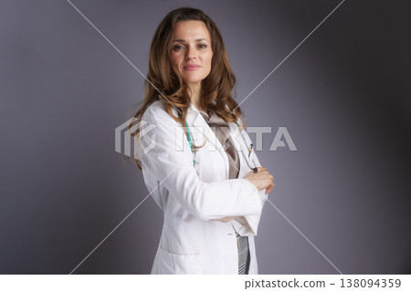 Serious Female Practitioner with Crossed Arms in Lab Coat 138094359