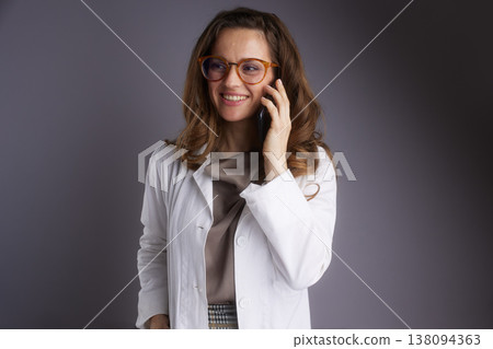 Cheerful Physician Having a Phone Consultation Cheerful Physician Having a Phone Consultation 138094363