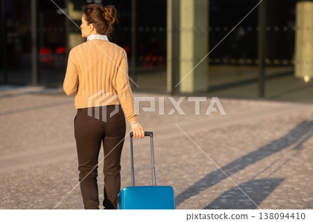 Solo Female Traveler Navigating Modern Railway Station Solo Female Traveler Navigating Modern Railway Station 138094410