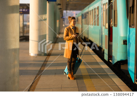 Solo Female Traveler Navigating Train Station with Smartphone Solo Female Traveler Navigating Train Station with Smartphone 138094417