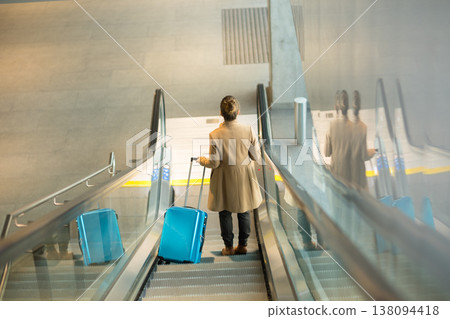 Rear View of Passenger Ascending Station Escalator 138094418
