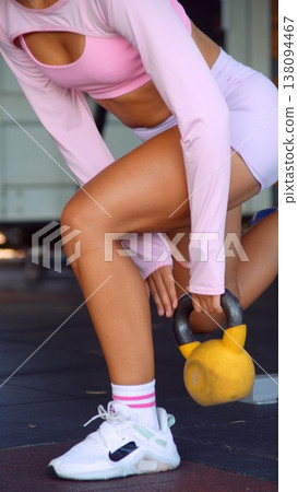 Gym session with woman doing targeted hip and leg exercises Gym session with woman doing targeted hip and leg exercises 138094467
