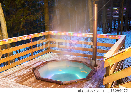 Closeup of steaming hot tub with icy railing and bubbling water Closeup of steaming hot tub with icy railing and bubbling water 138094472