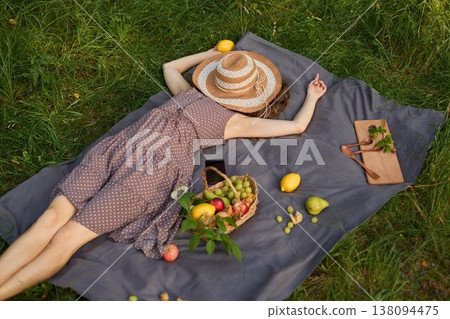 Tranquil image of lady lying on grass with fruits and natural elements Tranquil image of lady lying on grass with fruits and natural elements 138094475