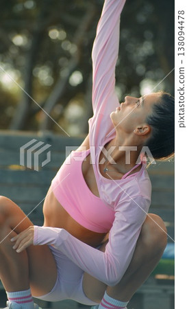 Female participant reaches high with deep inhalation and open posture Female participant reaches high with deep inhalation and open posture 138094478
