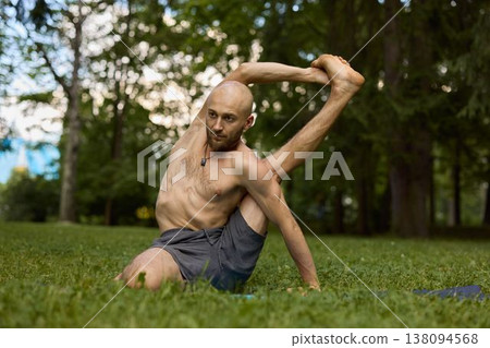 Gentle stretching session focusing on core and spinal flexibility outdoors 138094568