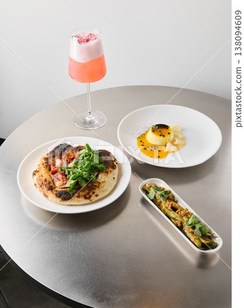 Vivid pink drink complemented by sleek modern tableware and garnish Vivid pink drink complemented by sleek modern tableware and garnish 138094609