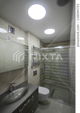Modern minimalist bathroom with bathtub and clear tiles. Nobody inside Modern minimalist bathroom with bathtub and clear tiles. Nobody inside 138094703