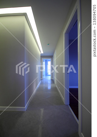 A long corridor with doors at the sides and a light at the end of the corridor A long corridor with doors at the sides and a light at the end of the corridor 138094705