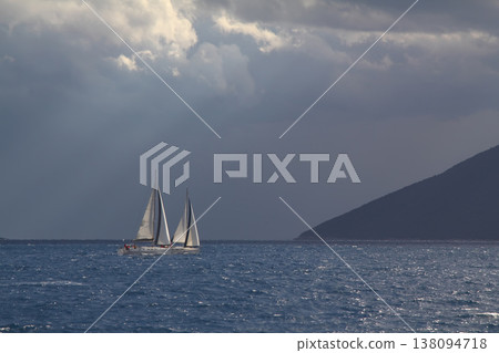 Close up on the bow of a sailboat breaking through a wave Close up on the bow of a sailboat breaking through a wave 138094718