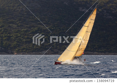 Close up on the bow of a sailboat breaking through a wave Close up on the bow of a sailboat breaking through a wave 138094719
