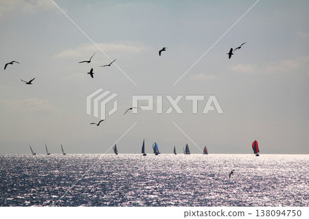 Sailboats sail in windy weather in the blue waters of the Aegean Sea, on the shores of the famous holiday destination Bodrum. 138094750