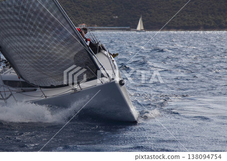 Close up on the bow of a sailboat breaking through a wave Close up on the bow of a sailboat breaking through a wave 138094754