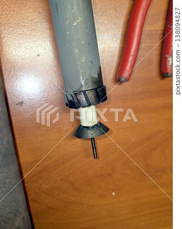 Igniter Part on a Wooden Surface With Tools Nearby Igniter Part on a Wooden Surface With Tools Nearby 138094827
