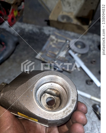 Close View of Industrial Igniter Part Held in Hand During Maintenance Work Close View of Industrial Igniter Part Held in Hand During Maintenance Work 138094832