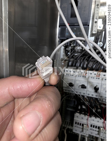 Installing a Network in a Tech Space With an Ethernet Connector in Hand 138094889