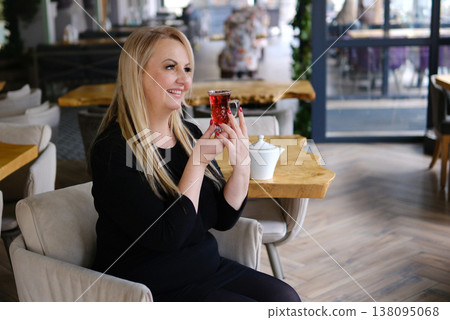 Elegant mature woman holding red drink glass posing confident glamour lifestyle indoor photo shoot sophisticated adult female Elegant mature woman holding red drink glass posing confident glamour lifestyle indoor photo shoot sophisticated adult female 138095068