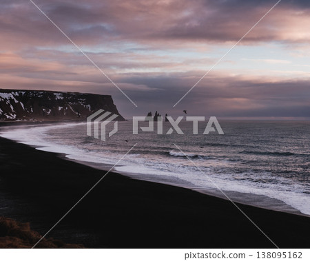 Reynisfjara black sand beach with Reynisdrangar sea stacks, South Iceland. Reynisfjara black sand beach with Reynisdrangar sea stacks, South Iceland. 138095162
