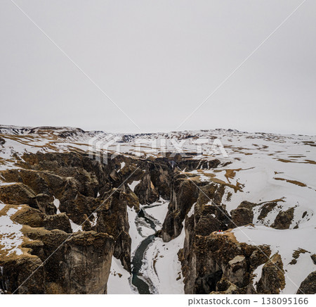 Snow-covered Fjadrargljufur canyon with a winding river, South Iceland. Snow-covered Fjadrargljufur canyon with a winding river, South Iceland. 138095166