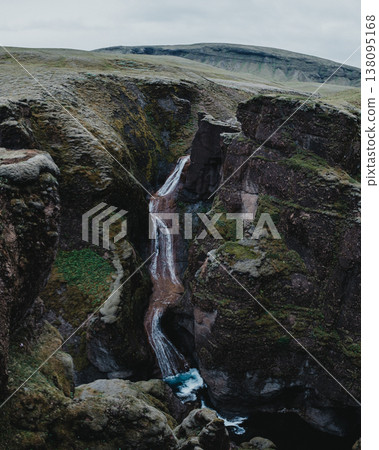 Moss-covered Mogafoss waterfall cascading through rugged cliffs, South Iceland. Moss-covered Mogafoss waterfall cascading through rugged cliffs, South Iceland. 138095168