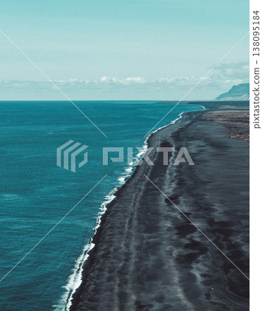 Aerial view of the black sand beach at Dyrholaey, South Iceland, with the vast Atlantic Ocean. Aerial view of the black sand beach at Dyrholaey, South Iceland, with the vast Atlantic Ocean. 138095184