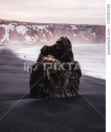 Arnardrangur sea stack on Reynisfjara black sand beach, South Iceland. Arnardrangur sea stack on Reynisfjara black sand beach, South Iceland. 138095190