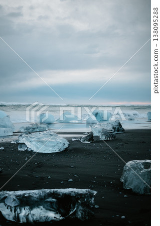 Scattered glacial ice on Diamond Beach under a moody sky, South Iceland. 138095288