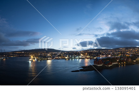Twilight panorama of Thorshavn, lights reflecting on harbor waters Twilight panorama of Thorshavn, lights reflecting on harbor waters 138095401